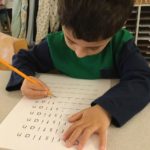 Child working in Language area practicing writing skills